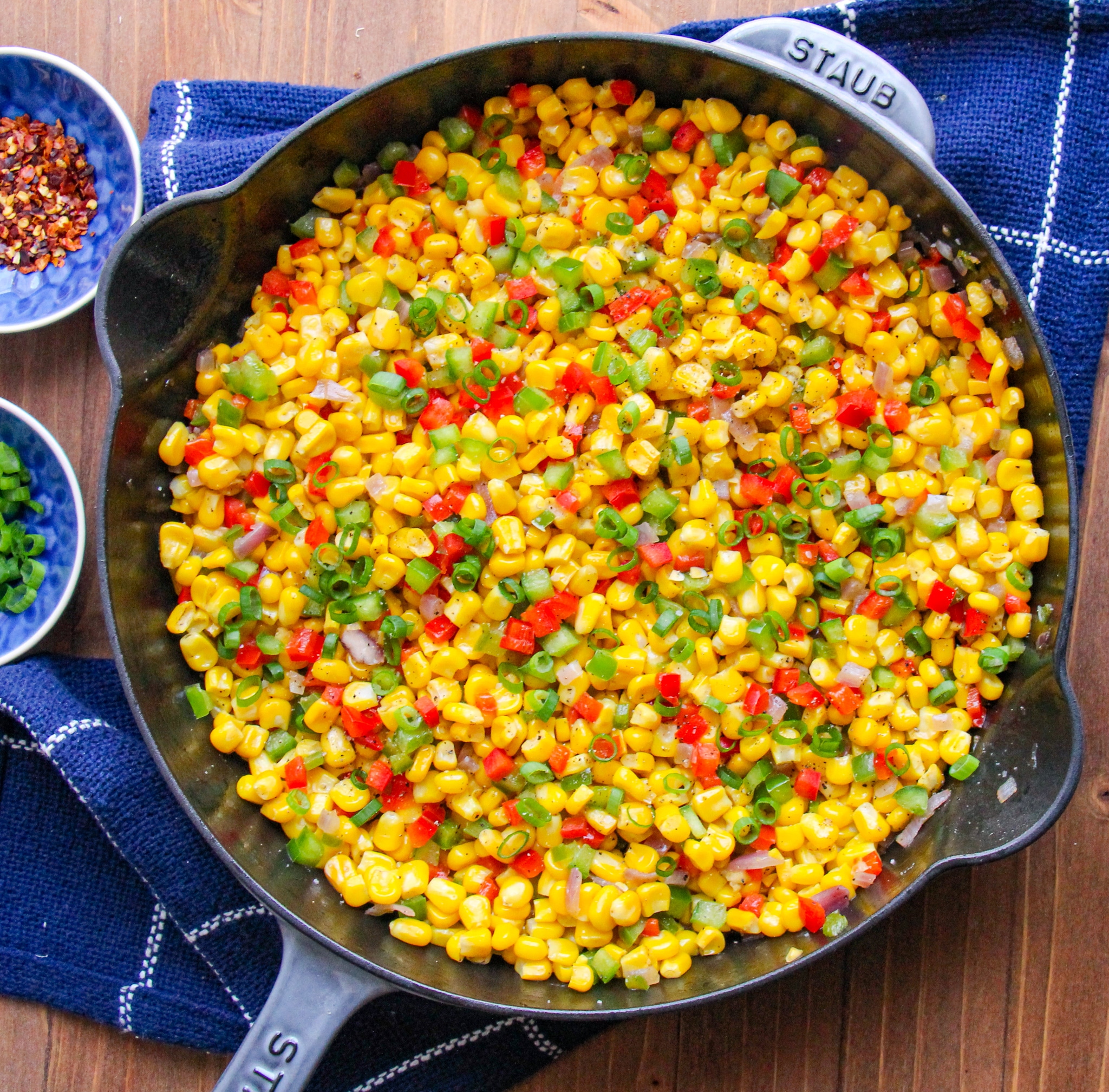 Confetti Corn in a skillet on top of a blue dish towel.
