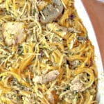 Fully cooked chicken tetrazzini in a casserole dish on wooden background.