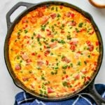 Western Omelette Frittata baked in a cast iron skillet garnished with chives