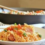 Easy Smoked Sausage and Rice Skillet served in a white bowl with fork.