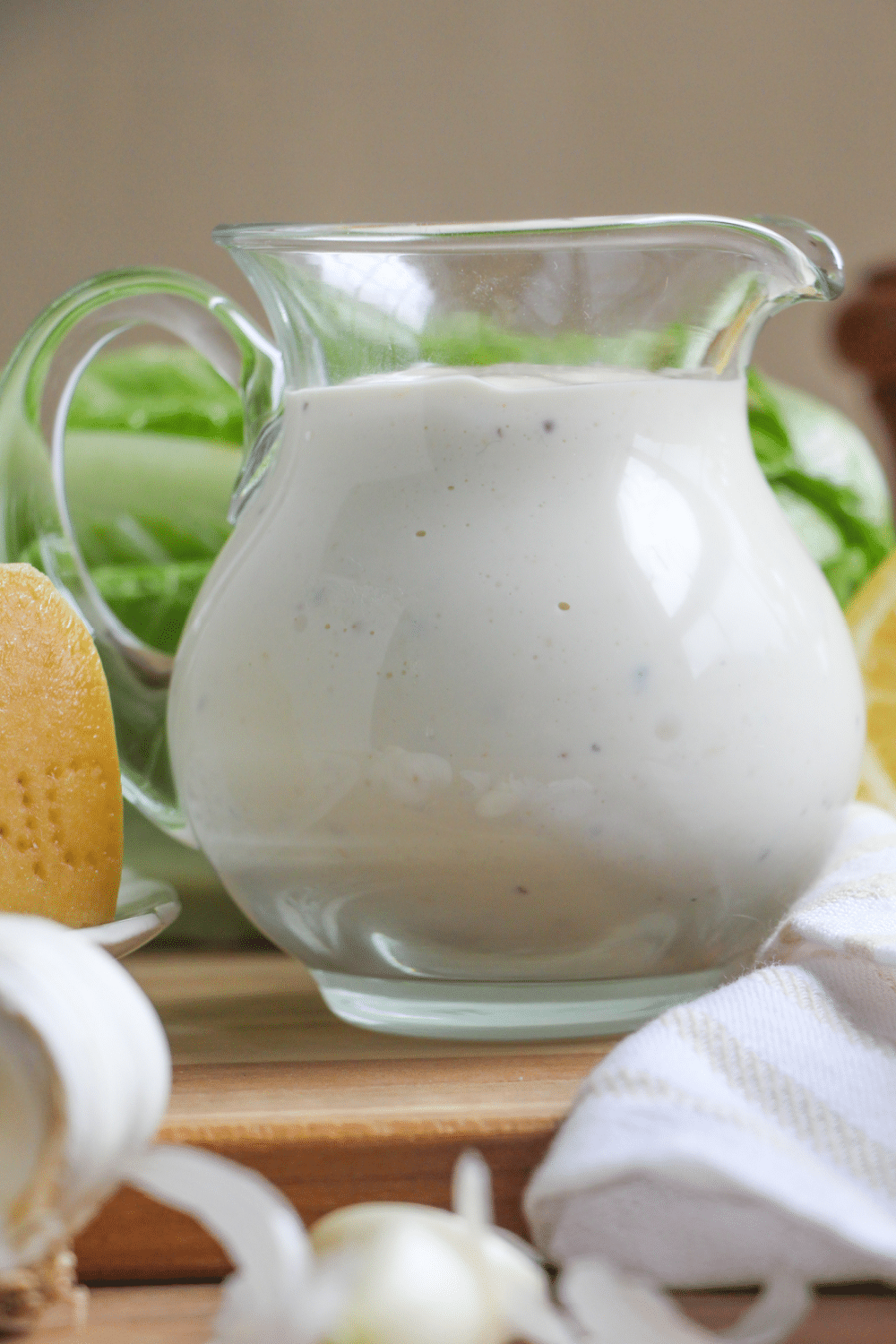 A small serving pitcher with Caesar dressing.