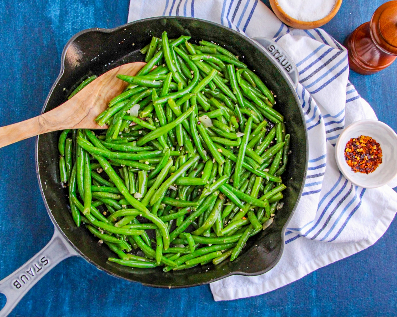 Green Beans in a skillet with blue and white dish towel 