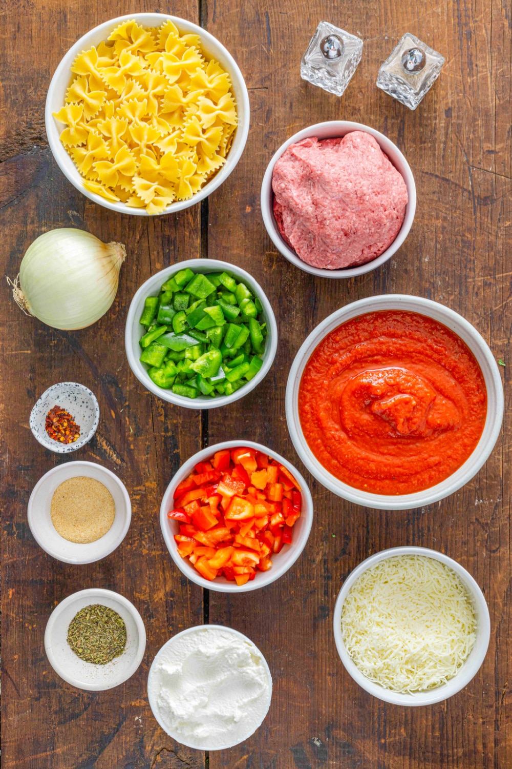 Measured ingredient need for this recipe presented I white bowls on a wood cutting board.