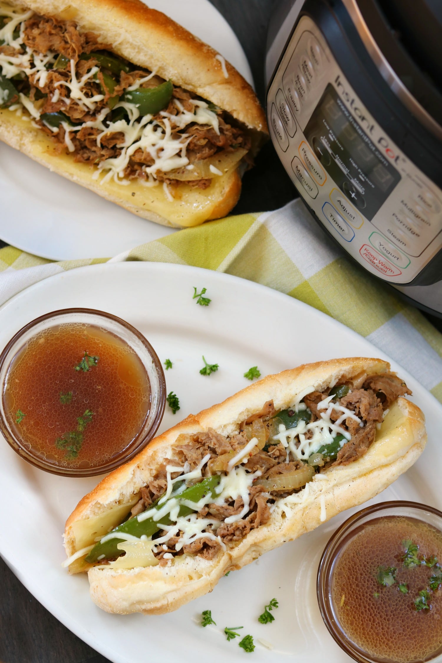 instant pot steak sandwiches with au jus on a white platter 