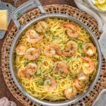 Lemon Garlic Parmesan Shrimp Pasta in a skillet garnished with cracked pepper and parsely.