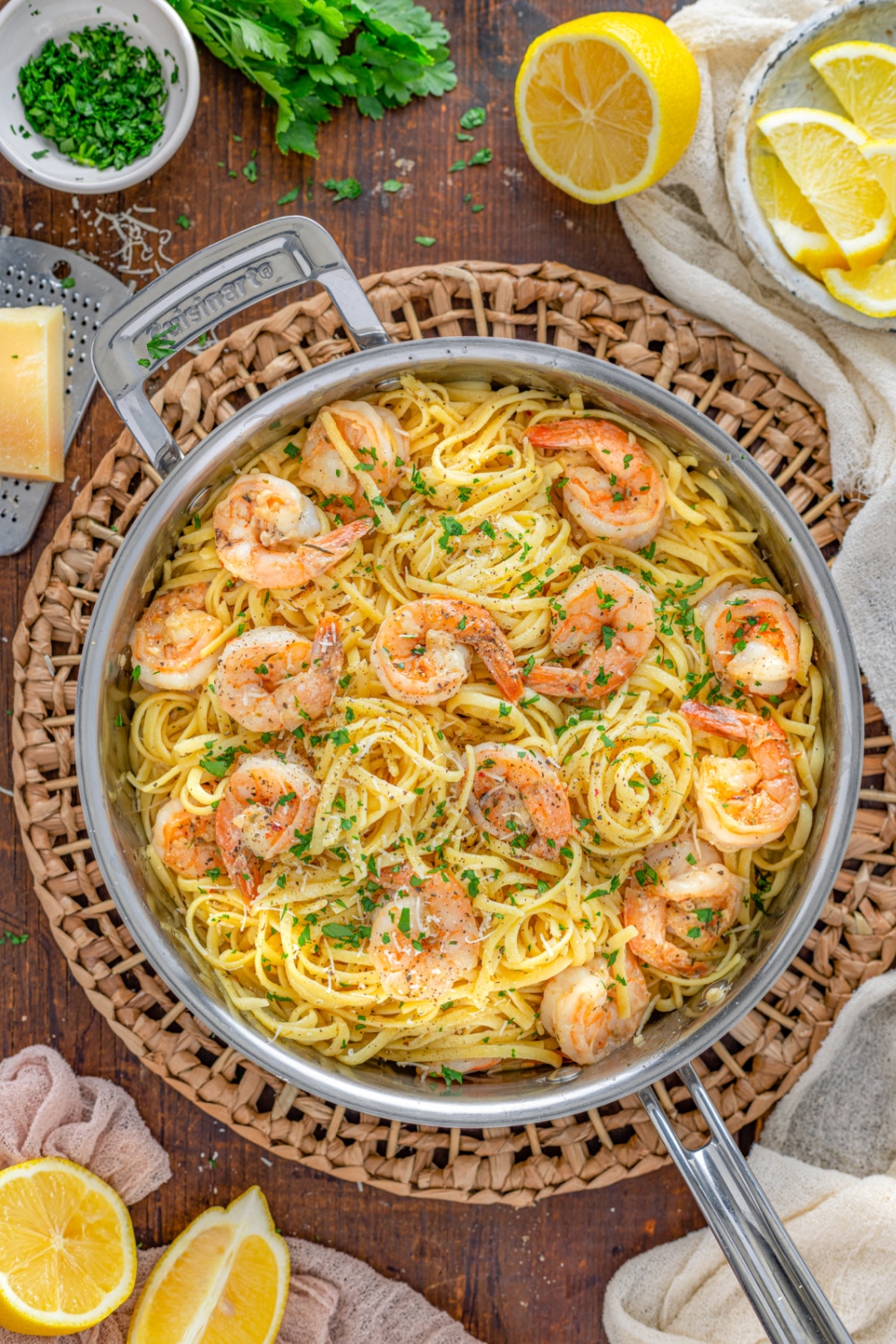 Lemon Garlic Parmesan Shrimp Pasta in a skillet garnished with cracked pepper and parsely. 
