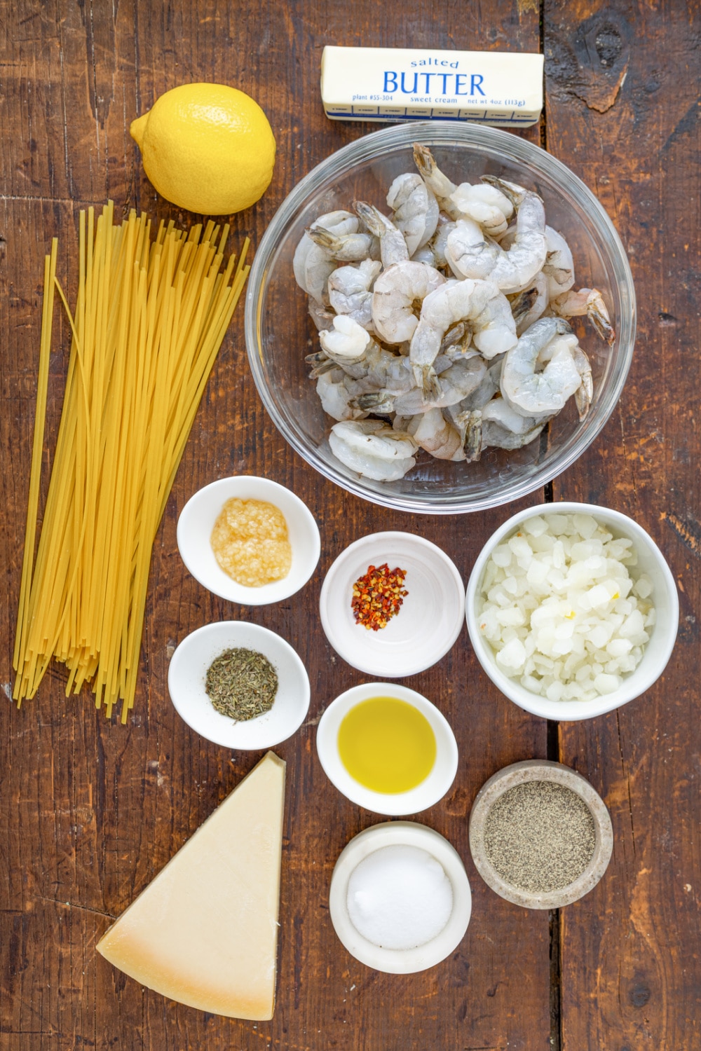 Ingredients needed to make this pasta recipe presented on a large wood cutting board.