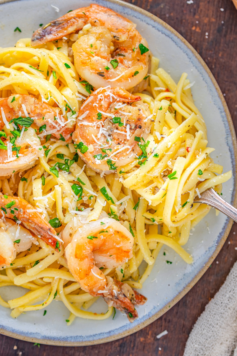 Pasta with shrimp on a plate with grated parmesan.