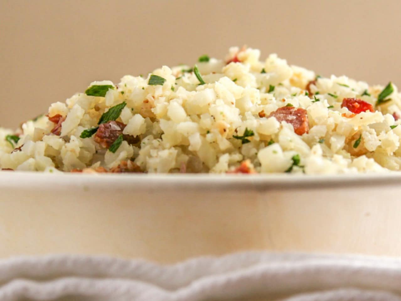 A bowl piled high with Bacon and Chive Cauliflower Rice 