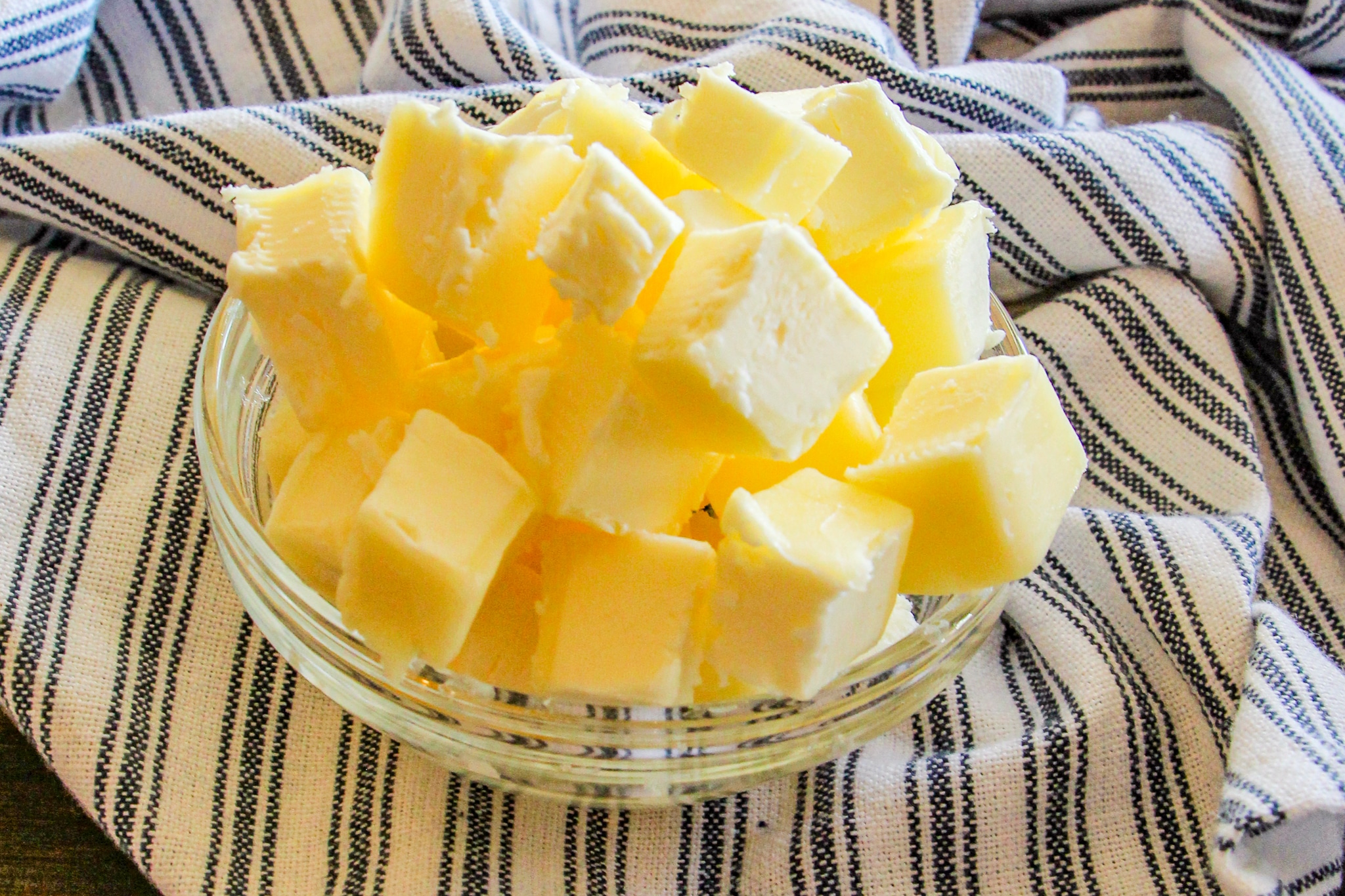 Butter in a small glass bowl cut into cubes for making Easy Drop Biscuits 
