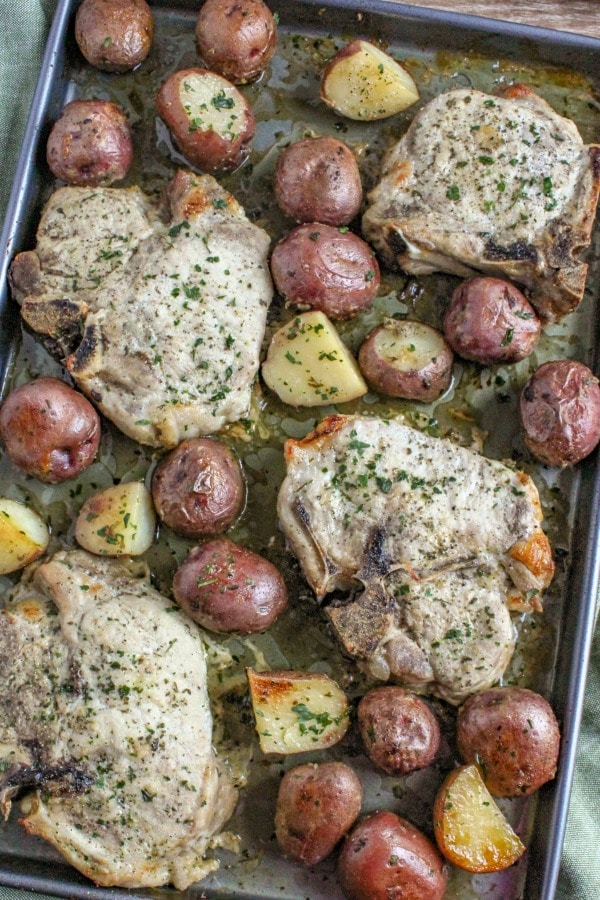 Ranch Pork Chops with Potatoes that have been baked on a sheet pan. 