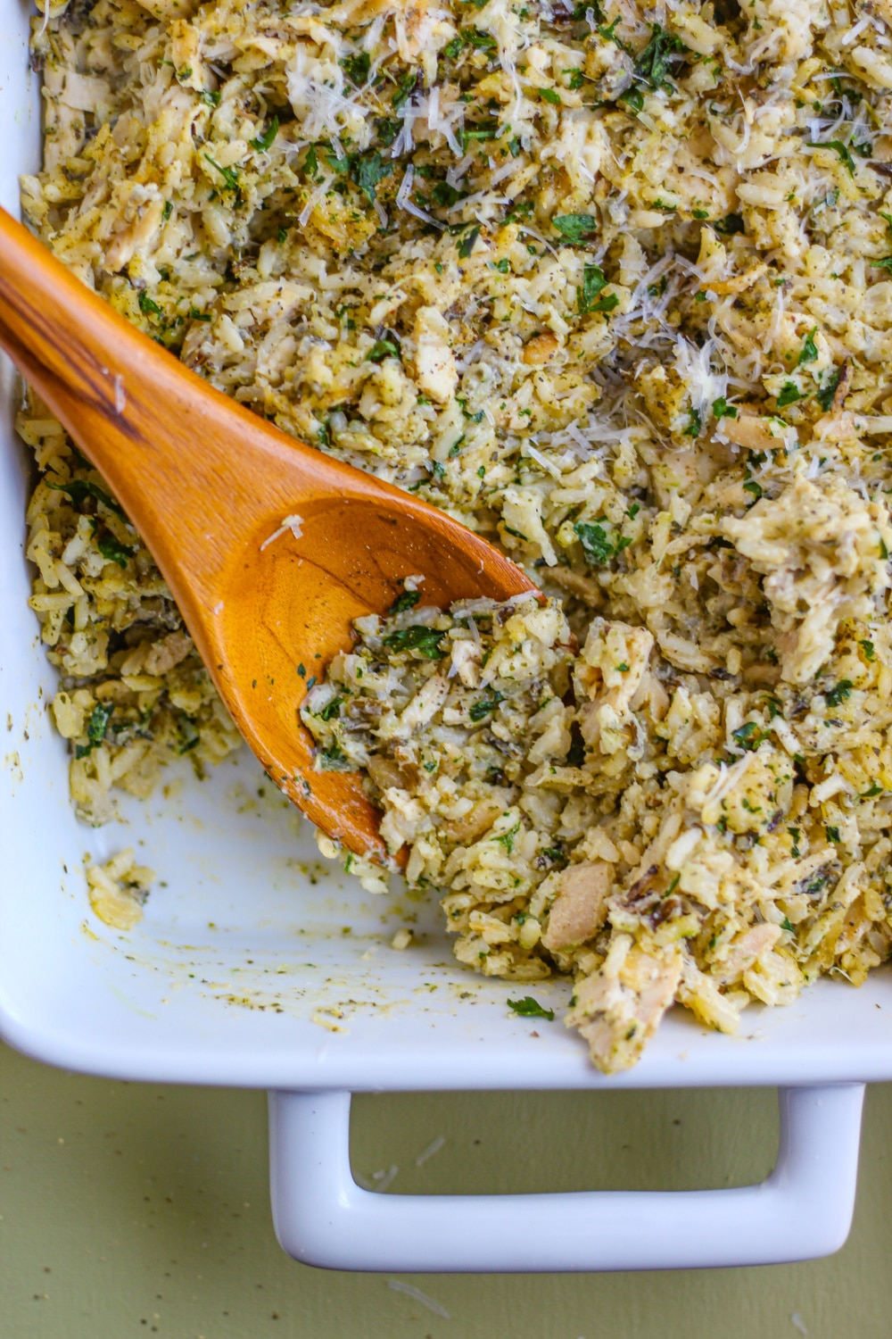 Chicken and Wild Rice Casserole in a white baking dish on a green background. 