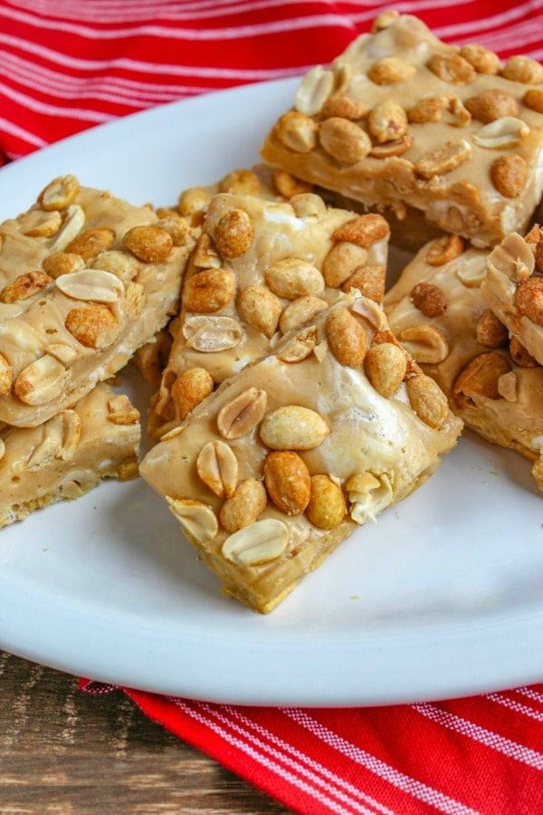 Salted Peanut Roll Bars on white platter on top of  red and white dish towel 