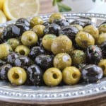 mixture of green and black marinated olives on a platter