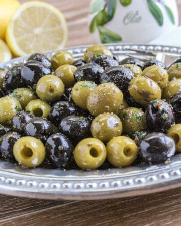 mixture of green and black marinated olives on a platter