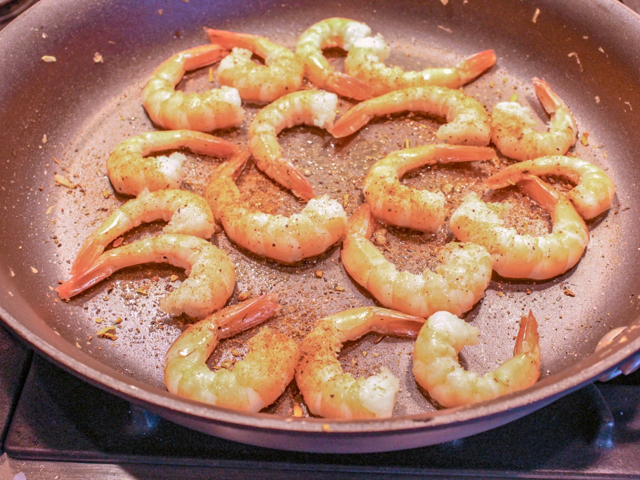 Cajun Shrimp recipe step three shrimp in skillet covered in cajun seasoning cooked until firm and pink 