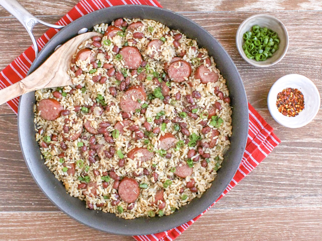 red beans and rice in pot with wooden spoon