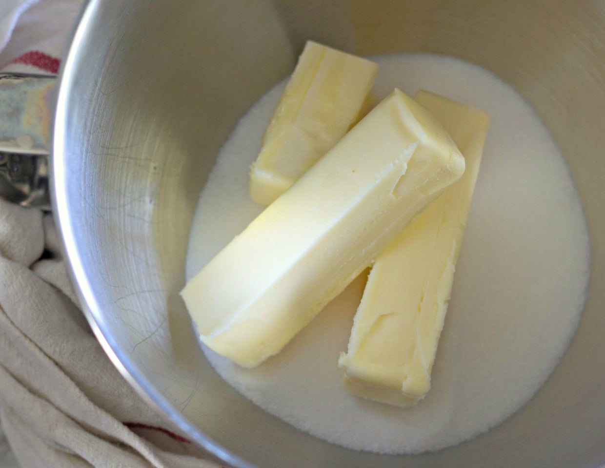 two and a half sticks of butter and sugar in a metal mixing bowl 