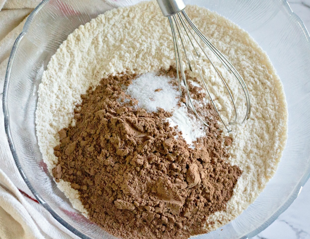 flour, cocoa, baking soda, and salt in a glass mixing bowl with whisk 