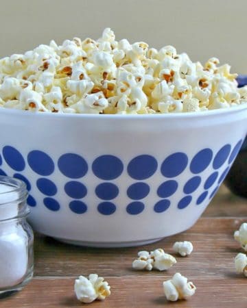 Stovetop Popcorn piled high is a white bowl with blue polka dots.