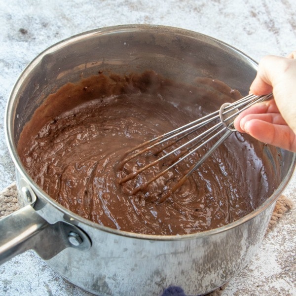 Chocolate Pie Recipe mixture in stainless steel pot and whisk 