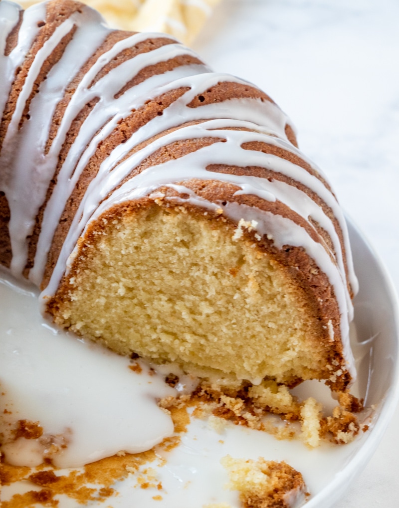 7 Up Bundt Cake with glaze sliced showing the moist yellow cake inside