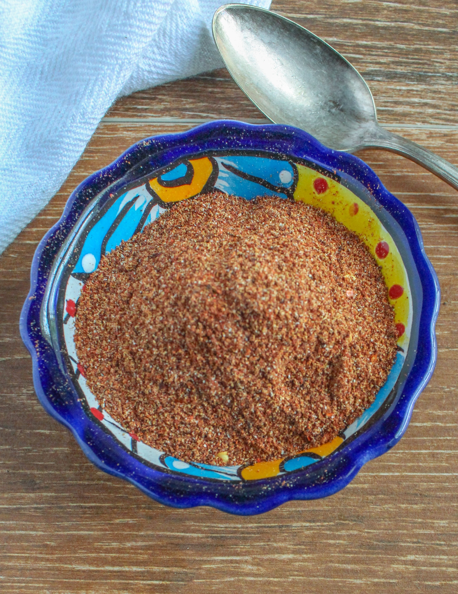 Homemade Taco Seasoning in a small colorful bowl on wooden background 