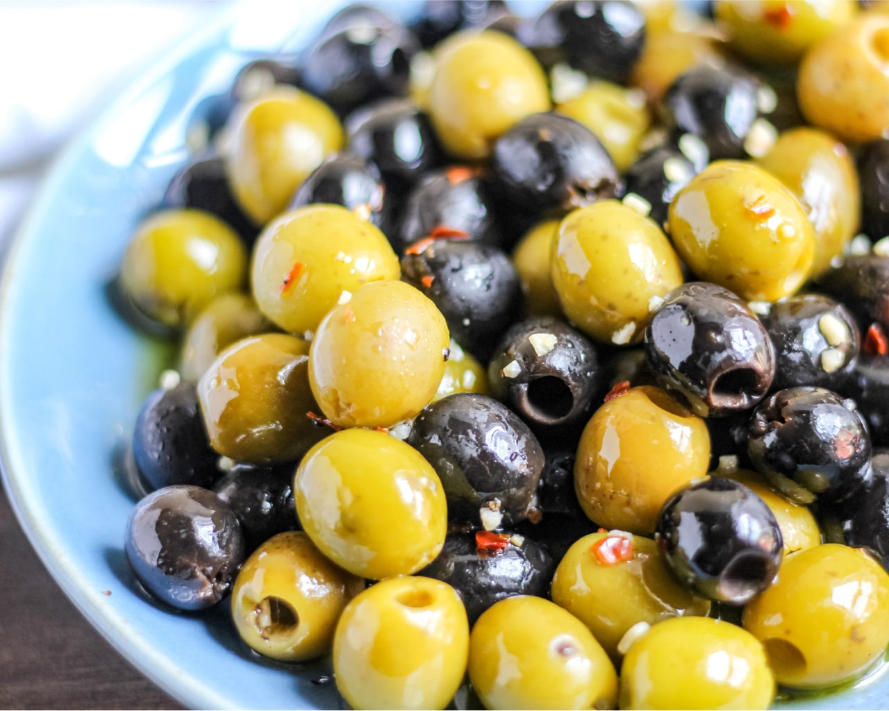 Citrus Marinated Olives in a blue serving bowl. 