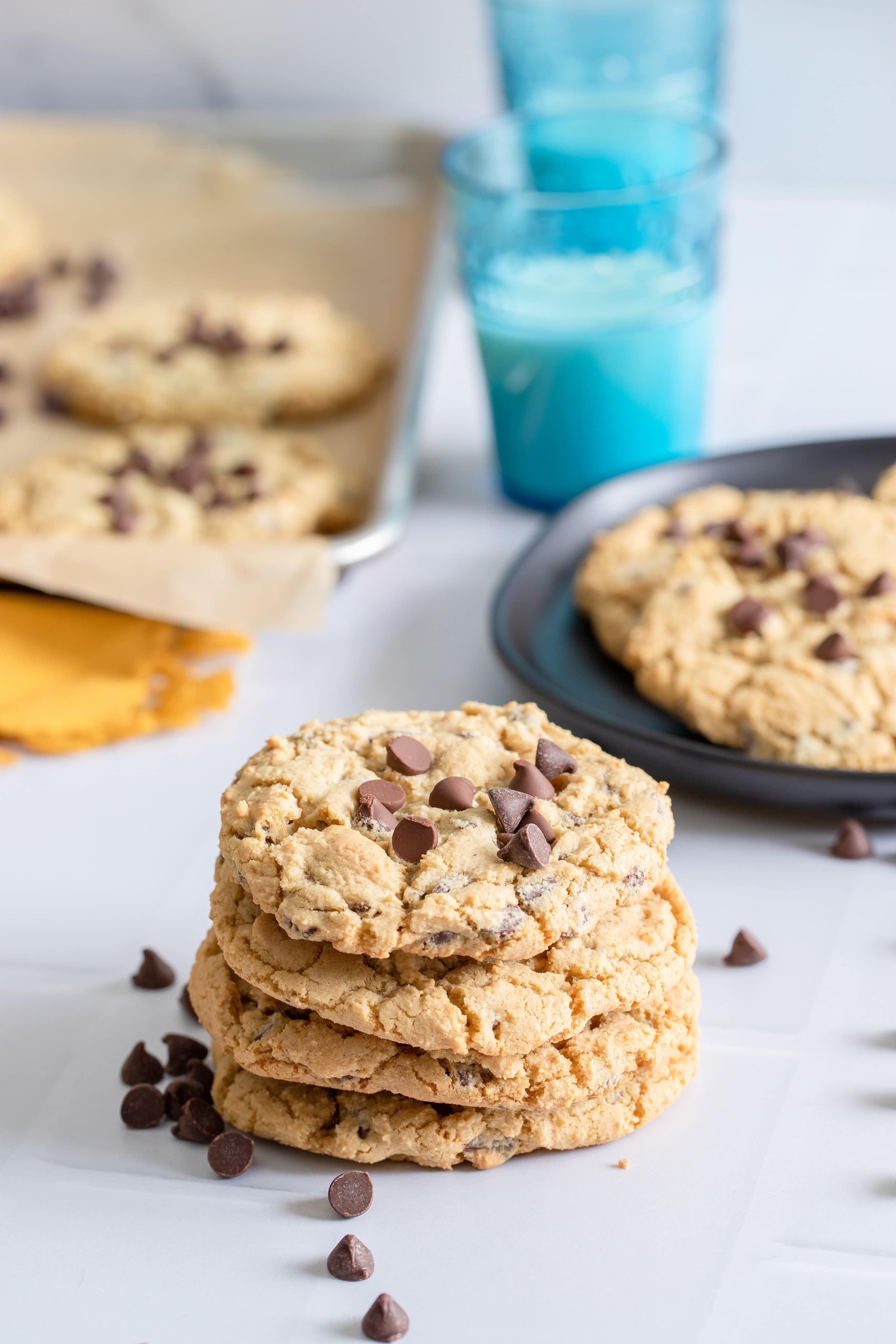 a stack of chocolate chip cookies on white background