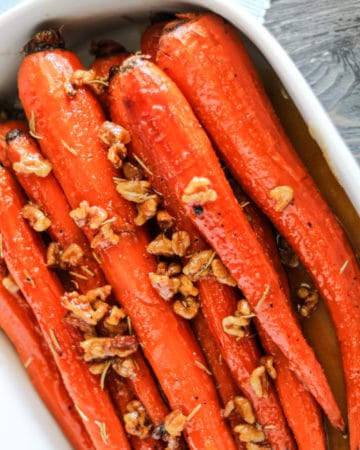 Honey and Maple Glazed i Carrots in a white serving dish.