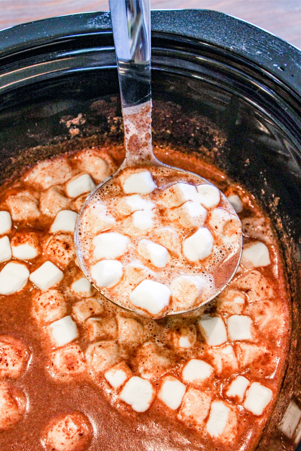 A ladle of hot cocoa with mini marshmallows
