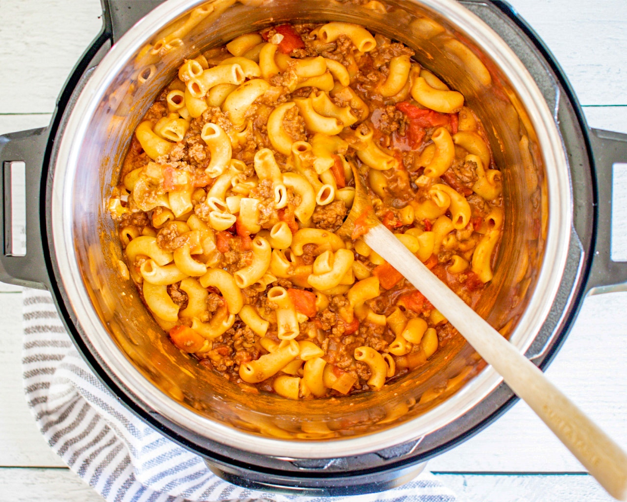 Prepared Goulash in an instant pot with wooden spoon