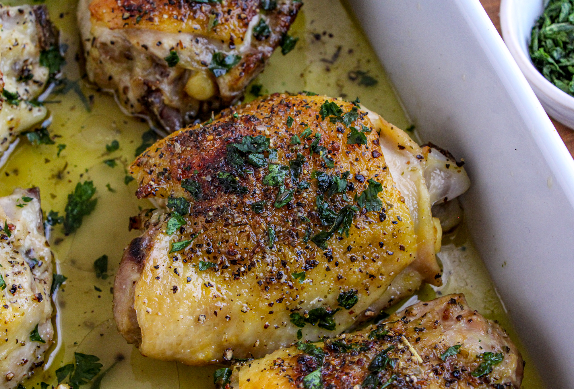 Lemon Pepper Chicken Thigh garnished with parsley and black pepper 
