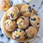 a basket full of blueberry muffins.