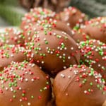 Oreo Truffles with red and green sprinkles displayed on a white tray