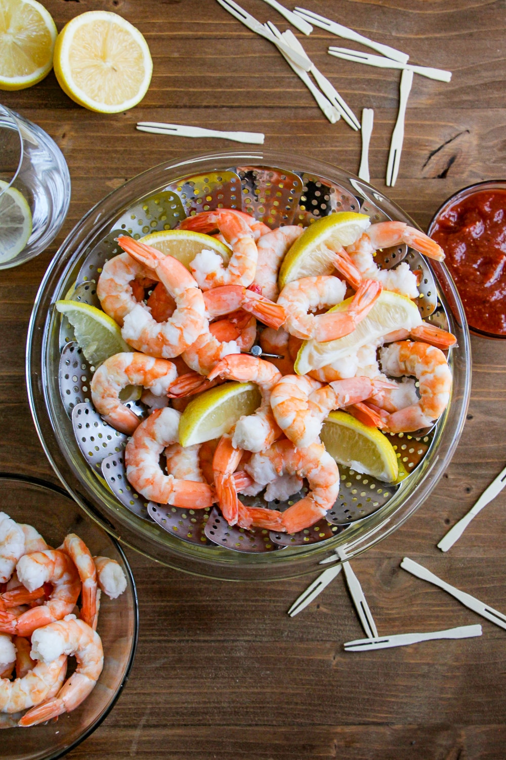 Shrimp in a steamer basket setting on a bowl of ice. 