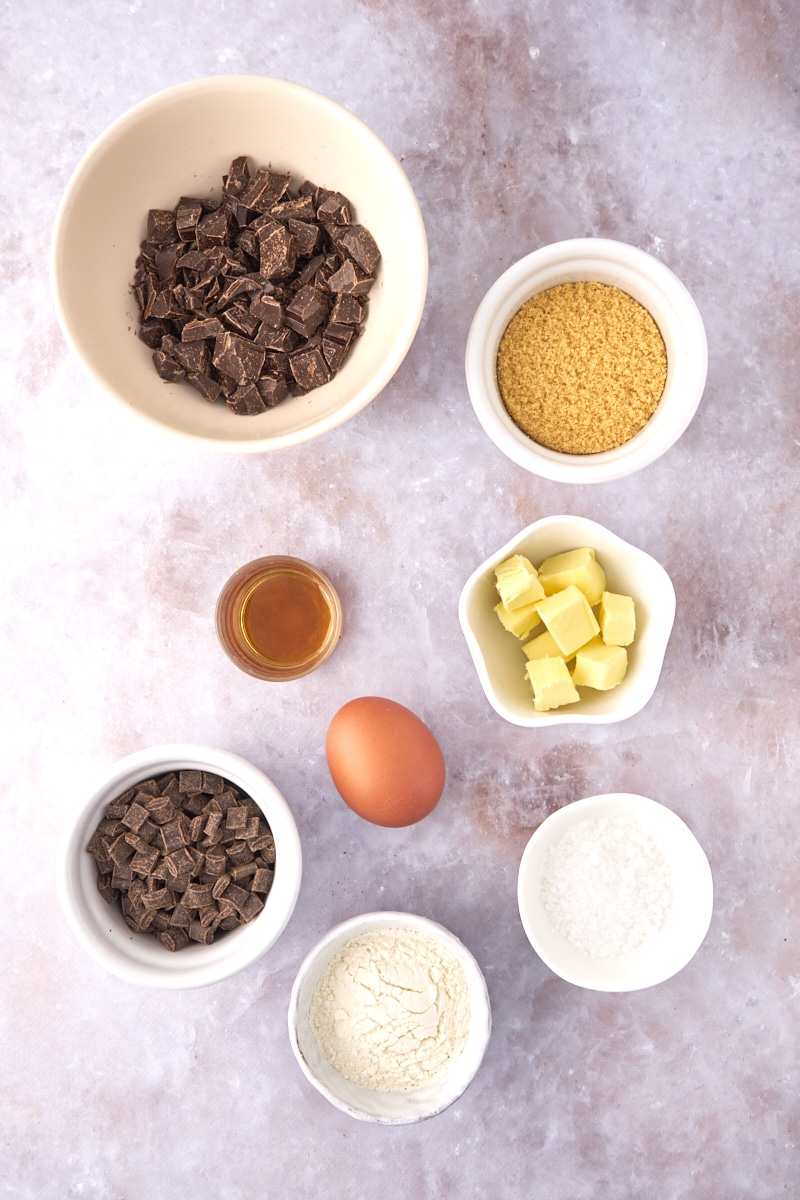 Measured ingredients in small bowls for making brownie cookies.