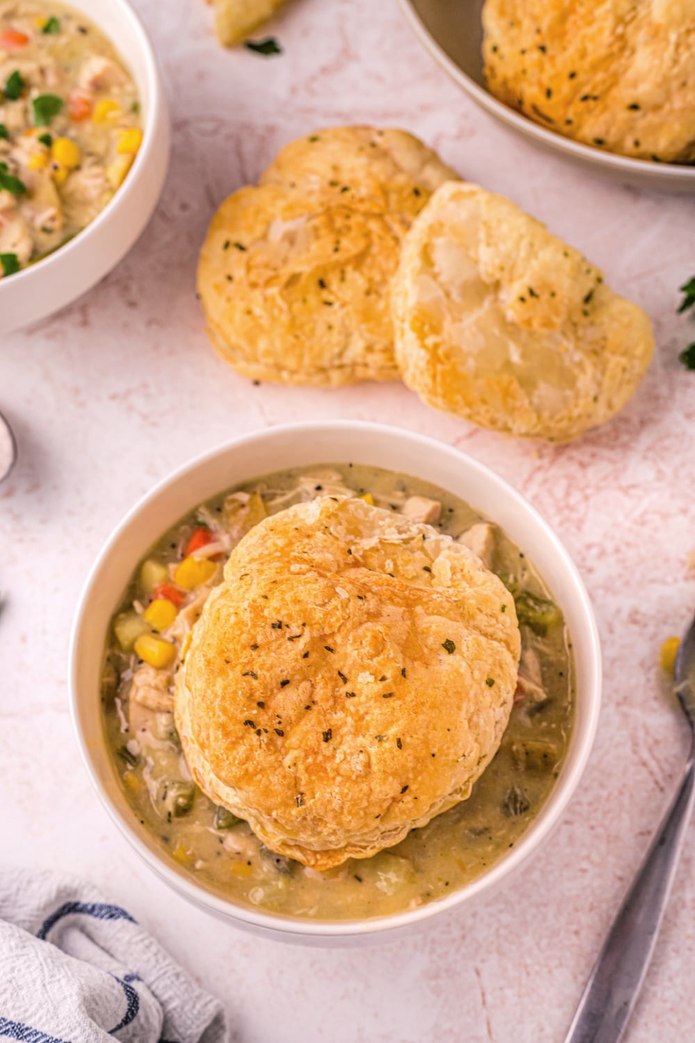 A bowl of Chicken Pot Pie Soup topped with a puff pastry biscuit. 