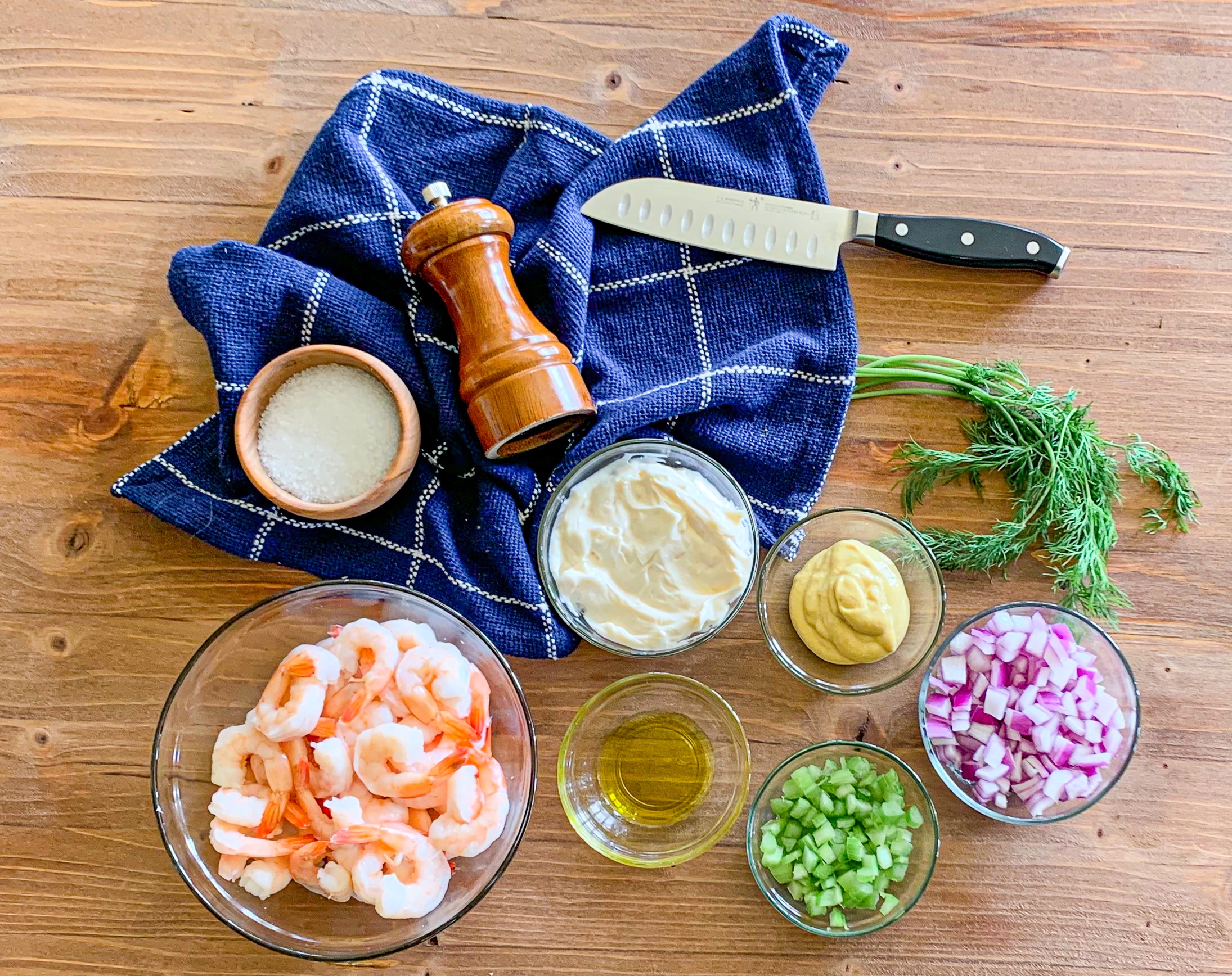 Measured Ingredients needed to make this recipe presented in clear bowls on a wood board.