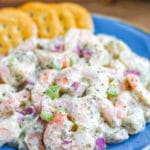 Shrimp Salad on a blue plate with crackers.