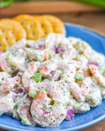 Shrimp Salad on a blue plate with crackers.