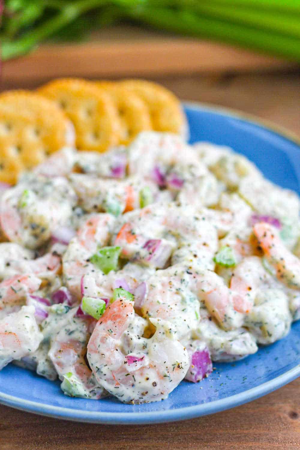 Shrimp Salad on a blue plate with crackers. 