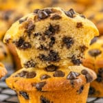 Two Chocolate Chip Mini Muffins stacked together with the top muffin sliced in half.