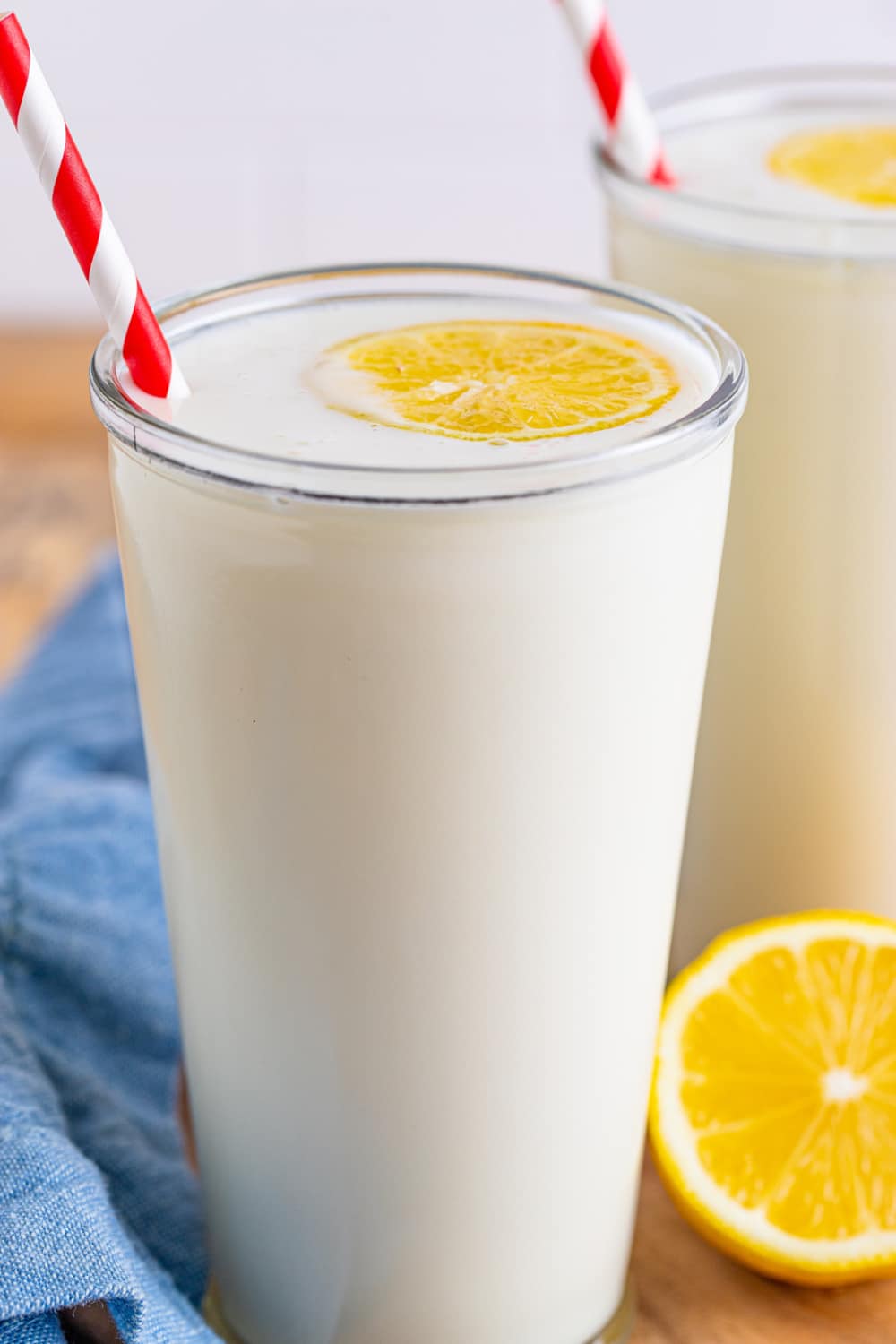 A glass of Frosted Lemonade with a red and white stripe straw.