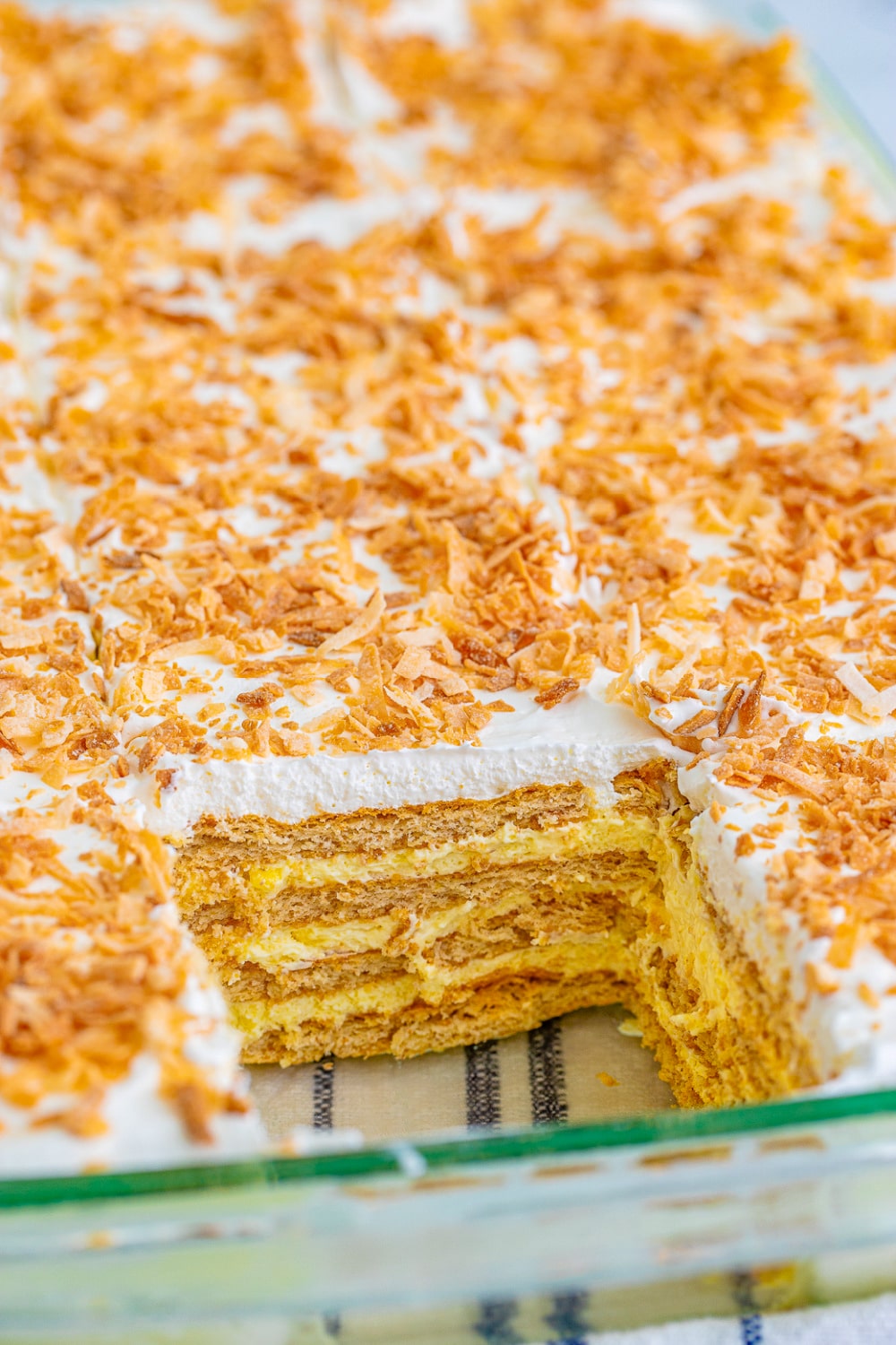 Coconut Icebox Cake in a clear glass cake pan.