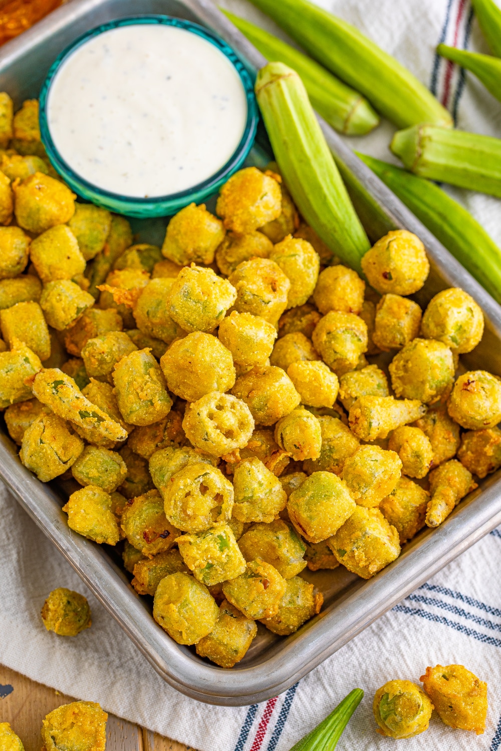 Fried Okra on a tray with a bowl of ranch dipping sauce.