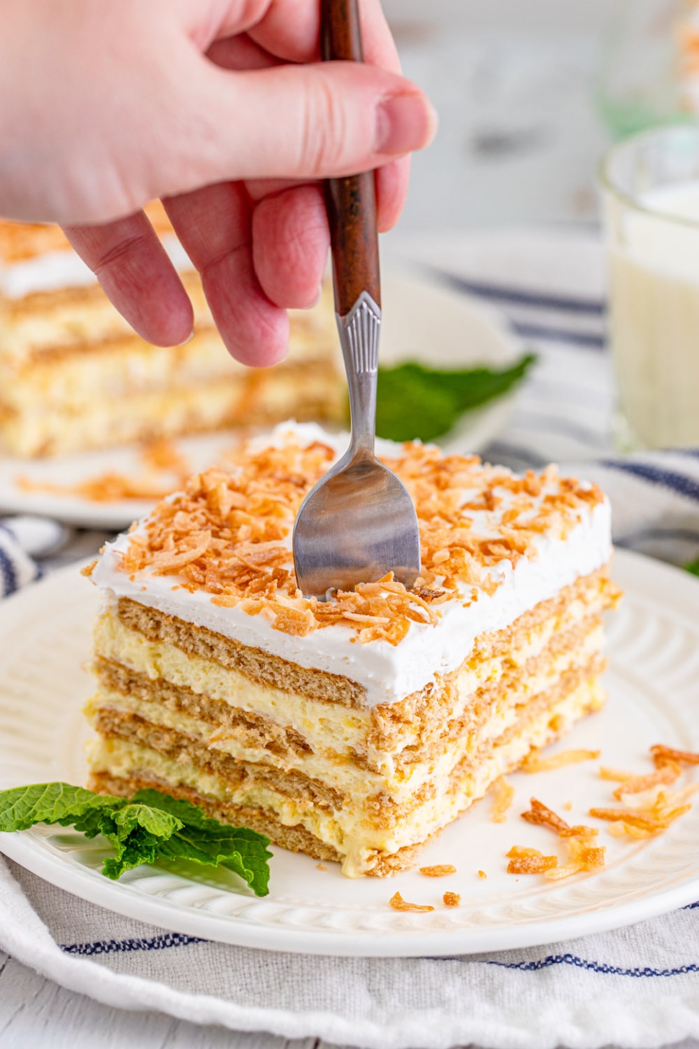 A fork stabbing into a slice of icebox cake.