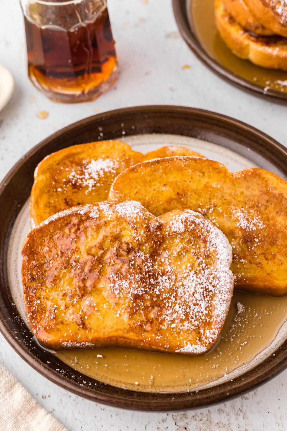 French Toast with syrup and a sprinkle of powdered sugar.