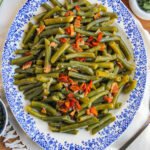 A blue and white platter loaded with Southern Style Green beans.