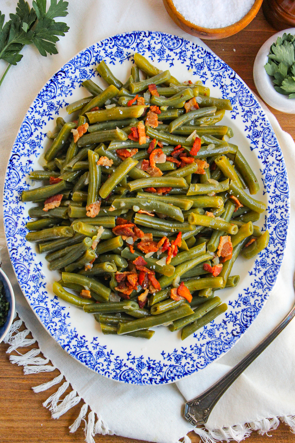 A blue and white platter loaded with Southern Style Green beans.